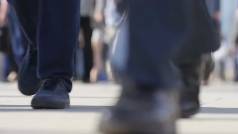Legs of pedestrian commuters walking to work in the morning rush, in slow motion Stock Footage 77609975