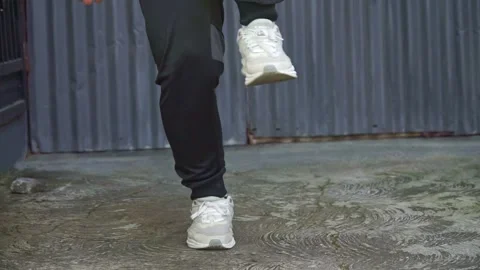 Legs of people doing basic leg stretches, captured from a low angle on an 库存影片 313640531