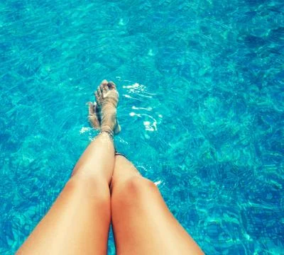 Legs in the pool Stock Photos
