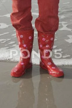 Legs With Red Pants And Red Rubber Boots On The North Sea Beach, Vejer Beach,