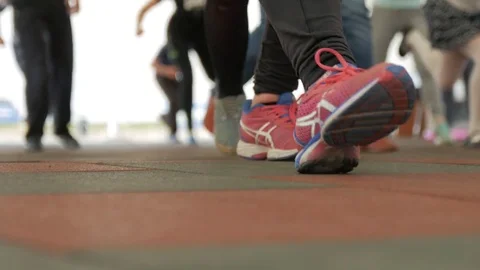 Legs in red shoes doing exercises. Closeup. Stock Footage 75244720
