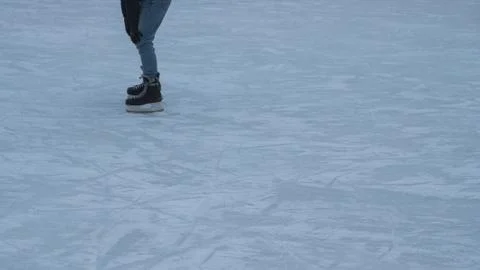 Legs ride a guy skating on the ice rink Stock Photos