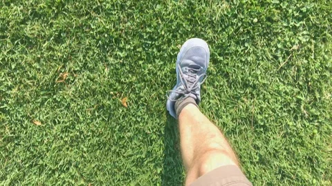 Legs that run on the lawn from the point of view of the runner Stock Footage 120519330