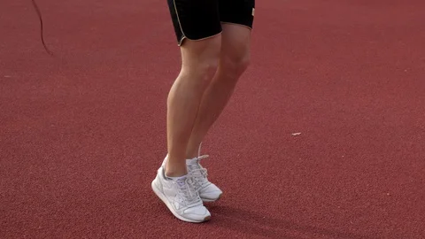 Legs of runner while jumping with a jumping rope Stock Footage 130138515