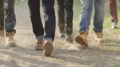 Legs of several men in jeans and brown boots Stock Footage 237488639