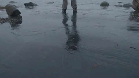 Legs of single man standing at the end of a lake  Stock Footage 146288766