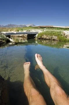 Legs Soaking In Hot Spring Stock Photos