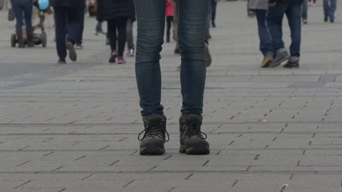 Legs stand still while many people pass by Stock Footage 74675268