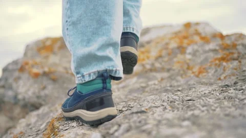 The legs of tourists go through the mountains on a journey. adventure mountains Video stock 289545461