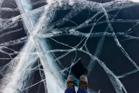 Legs on transparent ice Stock Photos