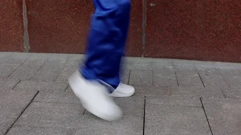 Legs in trousers dancing outdoors in city 스톡 동영상 172472553