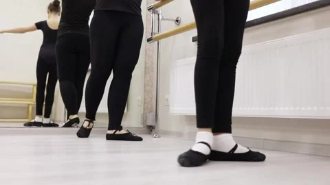 Legs of two ballet dancers practicing in a bright Stock Footage 299641663
