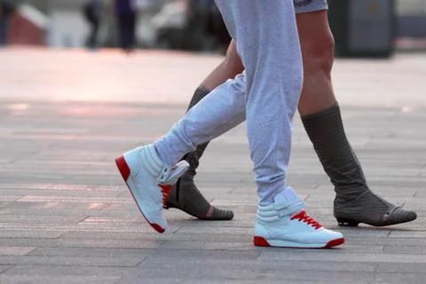 Legs of two people walking Stock Photos