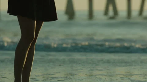 Legs walk past surf break out of focus, slightly handheld, 48fps Stock Footage 24673565