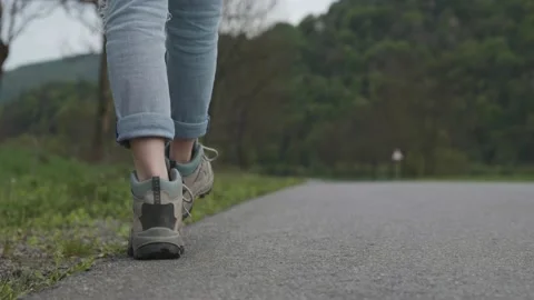 Legs walking along the roadside Stock Footage 130971947