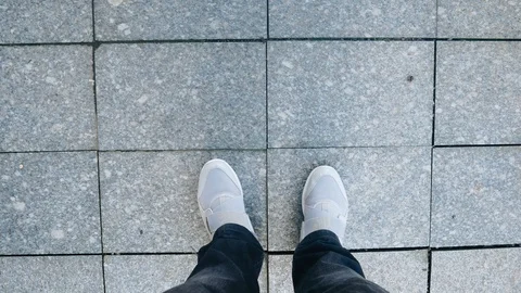 Legs walking down the sidewalk, top view Stock Footage 104954694