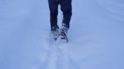 Legs walking forward through ankle-deep snow Stock Footage 123300008