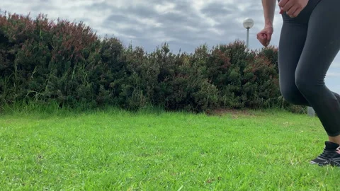 Legs when running, a man runs on a green lawn Stock Footage 137758534