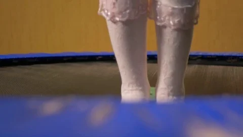 Legs in white socks jumping on a trampoline, close-up Video stock 72861892