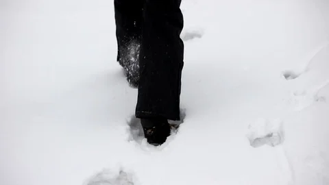 Legs in Winter Boots Making a Pass Through Thick Snow. Close up on Shoes. Видео 71794263
