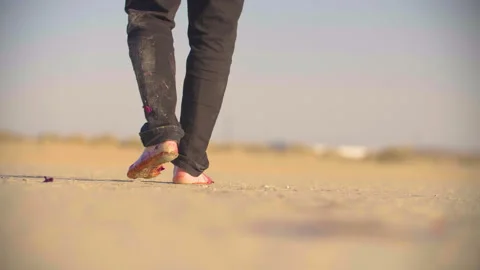 Legs of a wounded man stumbling across the desert Stock Footage 293113016