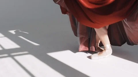 Legs of young dancers, class of ballet. Ballet dancer in a red skirt. Movement Stock Footage 73588360