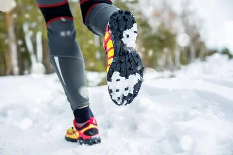 Legs of a young runner outside in winter nature Stock Photos