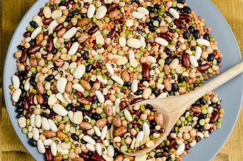 Legumes in a dish on wood, close up, background.. Stock Photos