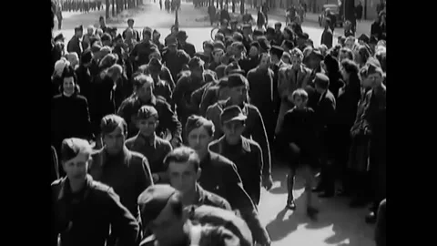 LEIPZIG - 1945 - German prisoners of war are marched through the streets of Stock Footage 296694053