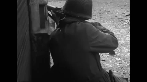 LEIPZIG - 1945 - US soldiers shoot rifles and talk on a telephone radio in the Video stock 284653338
