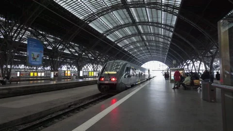 Leipzig, Germany - 11/23/2023: Electric train leaving architectural scenic Stock Footage 258407311