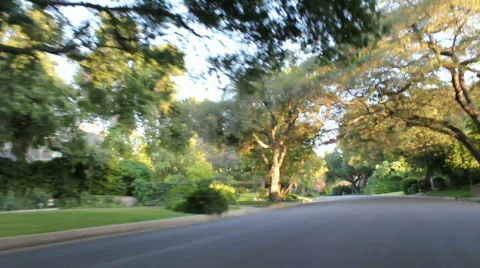 Leisure drive down tree lined streets Stock Footage