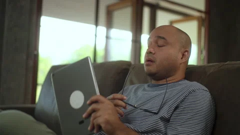 Leisure time of man using social media on tablet on sofa in living room in holid Stock Footage 269192945