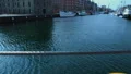 Leisure tourist boat sailing along Nyhavn harbor, travel activity in Copenhagen HD Footage