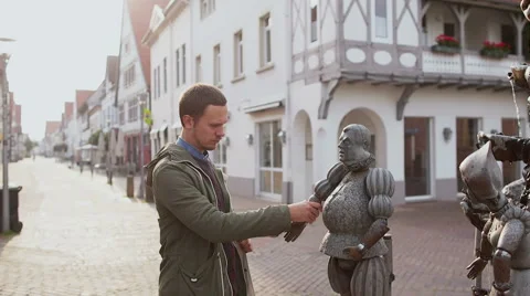 LEMGO, GERMANY Man touching statue. Stock Footage 66383384