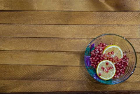 Lemon and garnet in a bow Stock Photos