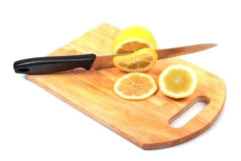 Lemon and knife on hardboard Stock Photos