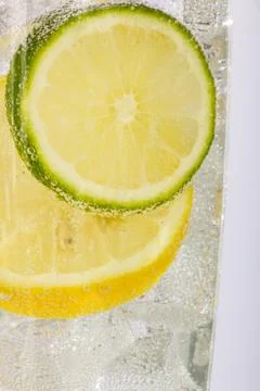 Lemon and Lime Slices with Bubbles in Soda Water Stock Photos