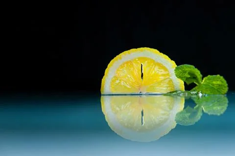 Lemon and mint on a dark background Stock Photos