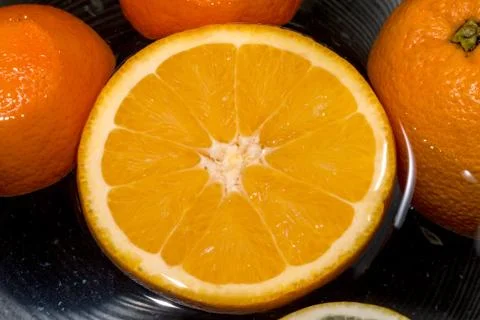 Lemon and tangerine float on the water 스톡 사진