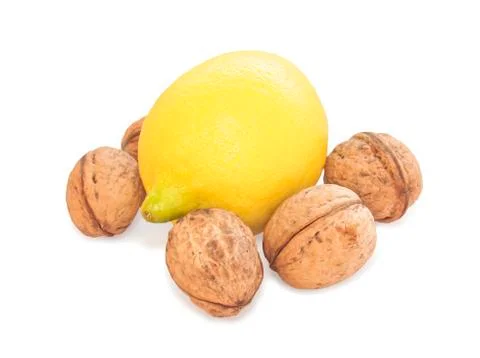 Lemon and walnut on white background Stock Photos