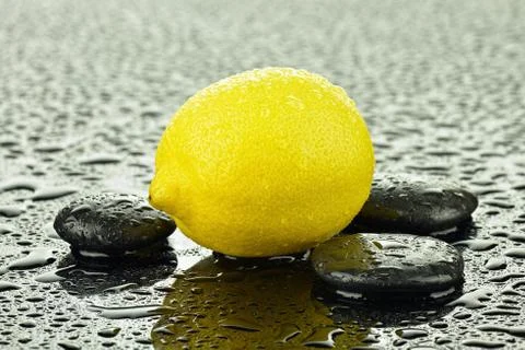 Lemon with basalt stones Stock Photos