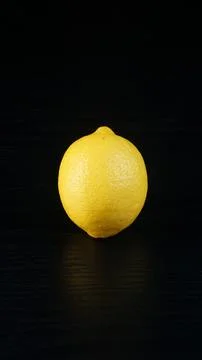 A lemon on a black table Stock Photos
