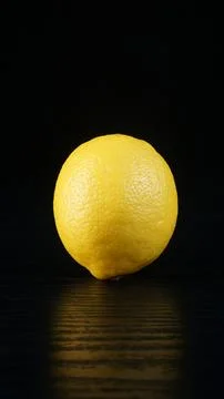 A lemon on a black table Stock Photos