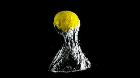 Lemon Blasting Through Water Stock Photos