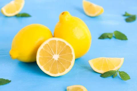 Lemon on the blue wood table with mint Stock Photos