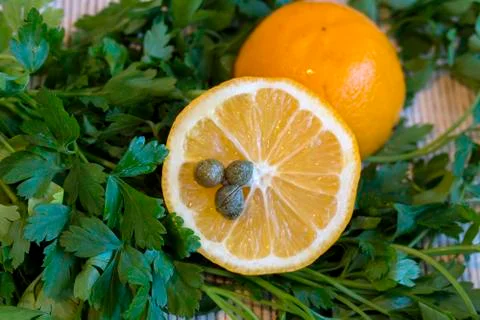 Lemon with capers. Stock Photos