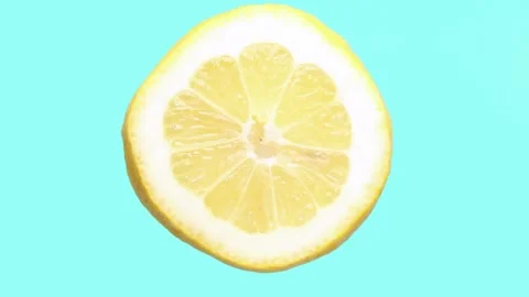 Lemon close-up rotates cyclically on a highlighted blue background. Stock Footage 192331462