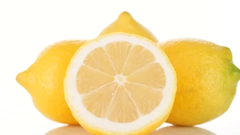 Lemon close up. Whole and half yellow lemons isolated on white background Video stock 229782855
