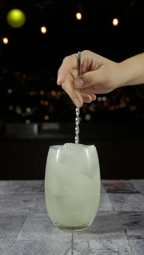 Lemon cocktail stirred with mint and citrus garnish Stock Footage 346264416
